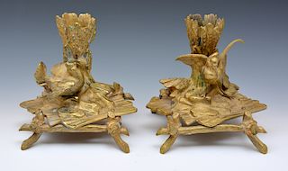 Pair of low bronze candlesticks with birds, wood, and wheat motif.