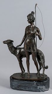 Patinated bronze of a woman and dog