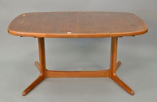 Danish modern teak dining table with two 20inch leaves, signed Rasmus. ht. 28 1/2in., lg. 59in., table opens to: 99in.