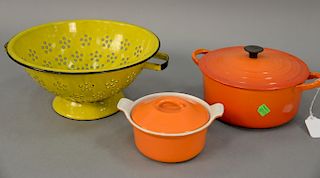 Large group of cast iron enameled cookware to include ten Le Creuset France orange enameled pots and pans, enameled strainer, and a ...