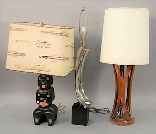 Three Mid-Century table lamps including Danish (ht. 36in.), chrome (ht. 36 1/2in.), and black pottery lamp marked F.A.I.P. (ht. 31 1/2in.).