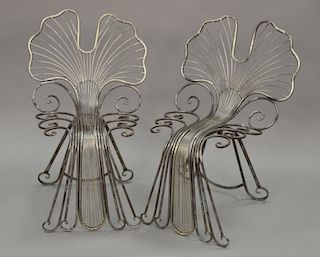 Pair of metal chairs with butterfly wing back.