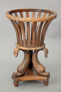 Mahogany plant stand with dolphin base. ht. 28 1/2in., dia. 19in.