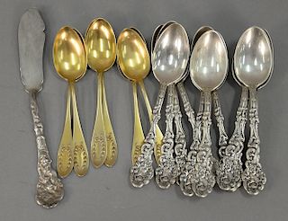 Nineteen piece lot to include Shreve & Lo gilt decorated tea spoons, thirteen Medici by Gorham spoons, and butterknife. 17.6 total t...