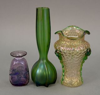 Three art glass vases to include Loetz Nautilus art glass vase (ht. 6 1/2in.), Loetz tall green bud vase (ht. 9in.), and a small pur...