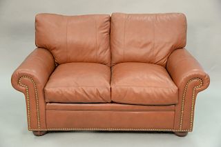 Leather upholstered loveseat. lg. 60in.