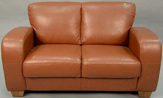 Leather upholstered loveseat. lg. 50in.