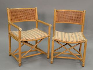 Set of six McGuire bamboo chairs, two armchairs and four side chairs, signed McGuire.
