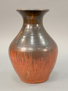 Red glazed pottery vase drilled for lamp.