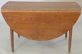 Oak drop leaf table. ht. 27 in., top closed: 21" x 54" Provenance: The Estate of Thomas F Hodgman of Fairfield, Connecticut