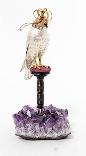 An Amethyst Mounted Silver Hooded Falcon, 20th Century, the falcon raised on a turned wood pedestal, having a fitted box.
