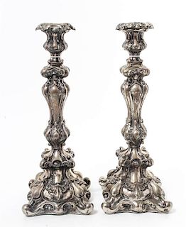 A Pair of Continental Silvered Metal Candlesticks, Late 19th/Early 20th Century, the undulating stems worked with volute and roc
