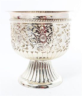A Repousse Decorated Silvered Metal Bowl, , raised on a circular foot.