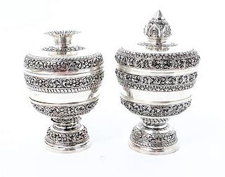 Two Silvered Metal Covered Cups on Stands, , each with alternating bands of scrolling decoration, each in a fitted box.