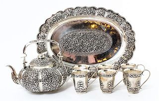 A Repousse Decorated Silver Tea Service, , comprising a teapot, tray and six cups.