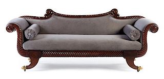 An Empire Mahogany Carved Sofa Height 34 1/2 x width 85 x depth 24 inches.