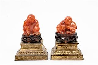 * A Pair of Chinese Carved Carnelian Agate Figures Height overall 5 inches.