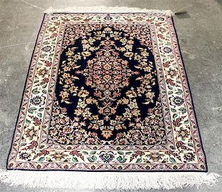 A Group of Four Wool Rugs Dimensions of largest 9 feet 7 inches x 6 feet 4 inches.