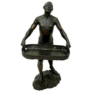 A Patinated Bronze Sculpture, Nubian Male Carrying Basket, Unsigned. Rubbing to surface overall goo