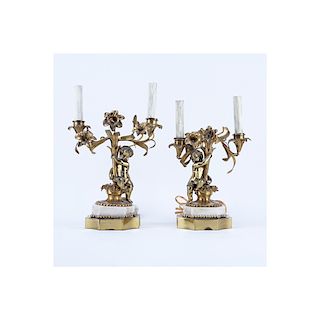 Pair of Gilt Brass Putti Two Light Electrified Candelabras. Each have been repaired, residue to sur