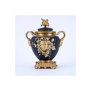 Neoclassical Style Gilt Brass and Painted Covered Urn with Bacchus Motif. Light rubbing to gilt ove