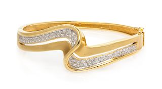 An 18 Karat Bicolor Gold and Diamond Bangle Bracelet, 23.90 dwts.