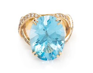 A 14 Karat Yellow Gold, Blue Topaz and Diamond Ring, 8.40 dwts.