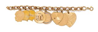 A 14 Karat Yellow Gold Charm Bracelet with 8 Attached Charms, Zelman & Friedman, 35.10 dwts.