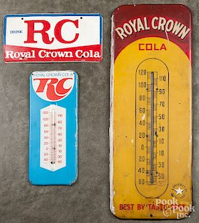 Two advertising thermometers and a sign