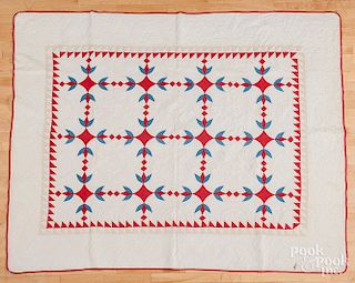 Red, blue and tan pieced quilt