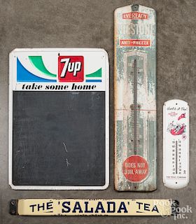 Two tin advertising signs and two thermometers