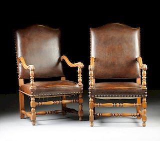 A PAIR OF BAROQUE STYLE NAILED BROWN LEATHER UPHOLSTERED CARVED WOOD ARMCHAIRS, 20TH CENTURY,