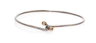 A Sterling Silver and 18 Karat Yellow Gold Bangle Bracelet, Tiffany & Co., 4.20 dwts.