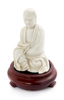 * A Chinese Blanc-de-Chine Porcelain Figure of a Luohan Height 4 inches.