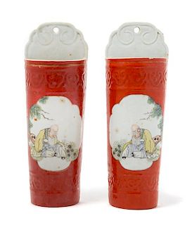 A Pair of Chinese Iron Red Ground Famille Rose Wall Vases Height of each 10 1/2 inches.