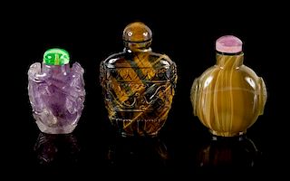 Three Chinese Carved Hardstone Snuff Bottles Height of tallest 3 1/2 inches.