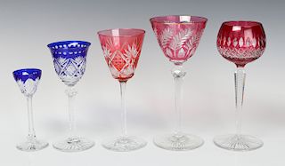 A COLLECTION OF COLORED CUT TO CLEAR CRYSTAL WINES