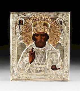 A RUSSIAN ICON OF ST. NICHOLAS THE MIRACLE WORKER WITHIN A SILVER PLATED OKLAD, LATE 19TH/EARLY 20TH CENTURY,