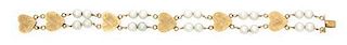 * A 14 Karat Yellow Gold and Double Strand Cultured Pearl Bracelet, 10.10 dwts.