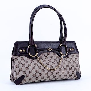 Gucci Beige/Brown Monogram Canvas And Leather Horsebit Tote Handbag. Brushed gold tone hardware, the interior of brown fabric with zippered pocket.