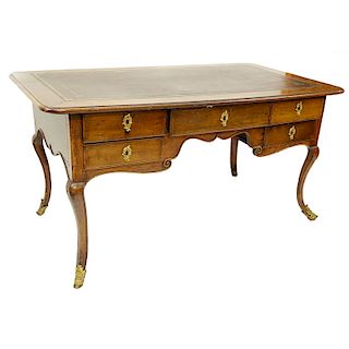 Large 19th Century French Walnut Writing Desk with Tooled Leather Top, Gilt Bronze Mounts. Large center drawer flanked by four fitted drawers, stands 