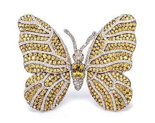 An 18 Karat White Gold, Yellow Sapphire, Ruby and Diamond En Tremblant Butterfly Pendant/Brooch, 29.00 dwts.