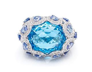 An 18 Karat White Gold, Blue Topaz, Sapphire and Diamond Ring, 13.40 dwts.