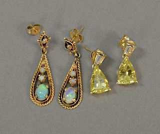 Two pairs of 14 karat gold pierced earrings, one with opals and one set with sapphires.