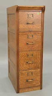 Oak four drawer file cabinet with recessed panel sides. ht. 53in., wd. 17 1/2in., dp. 27in.