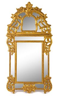 A Regence Style Giltwood Mirror Height 62 inches.