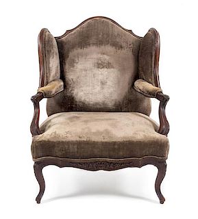 * A Louis XV Style Walnut Wingback Fauteuil Height 42 inches.