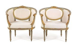A Pair of Louis XVI Style Painted and Parcel Gilt Bergeres Height 31 1/2 x width 30 5/8 inches.