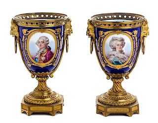* A Pair of Sevres Style Gilt Bronze Mounted Porcelain Urns Height 8 1/8 inches.
