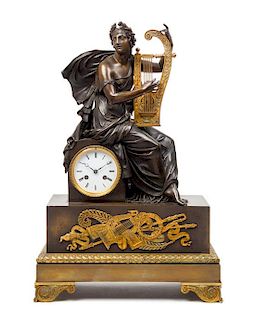 An Empire Style Gilt and Patinated Bronze Figural Mantel Clock Height 25 x width 16 3/8 x depth 6 7/8 inches.